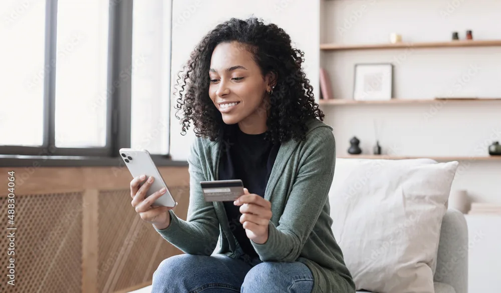 Smiling woman holding a credit card